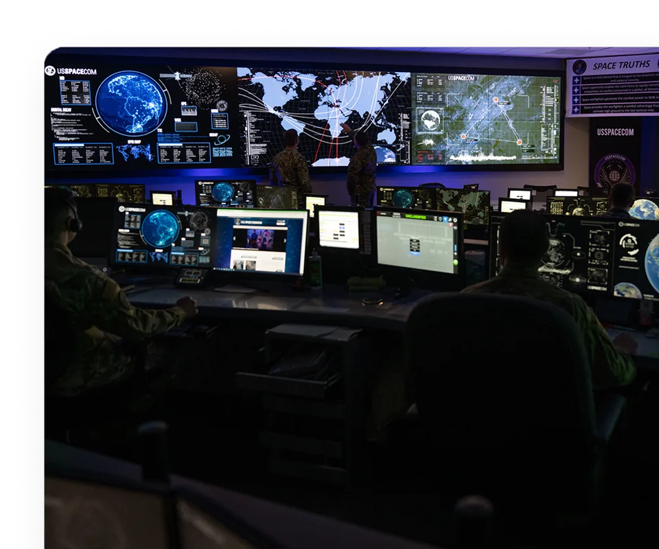 USSPACECOM operations room with wall-sized mission displays.